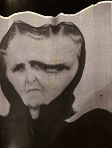 A distorted portrait of the author's grandmother. Her photo has been shifted or stretched beneath a scanner, widening and blurring her face.
